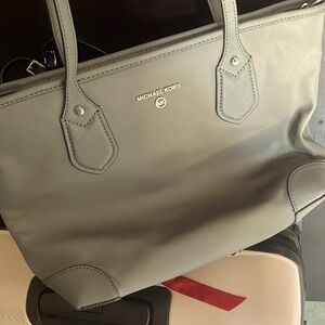 Grey mk purse . Material is like shark skin .